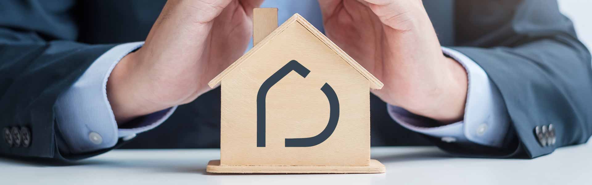 a small wooden house with Deyar's logo on its front and is surronded by protective hands.